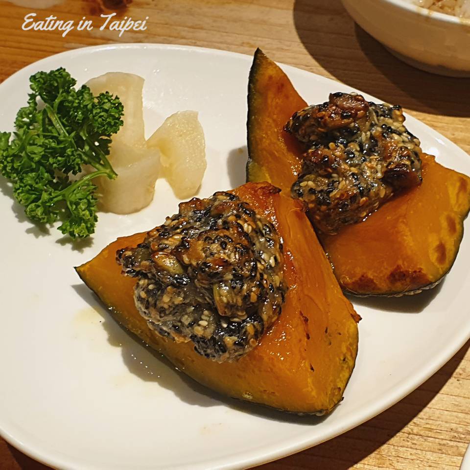 Thick slices of baked pumpkin with a crunchy sesame paste smeared on top.